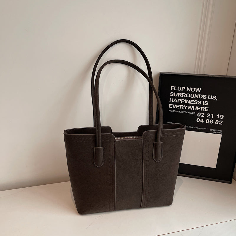 A shoulder bag exudes elegance.